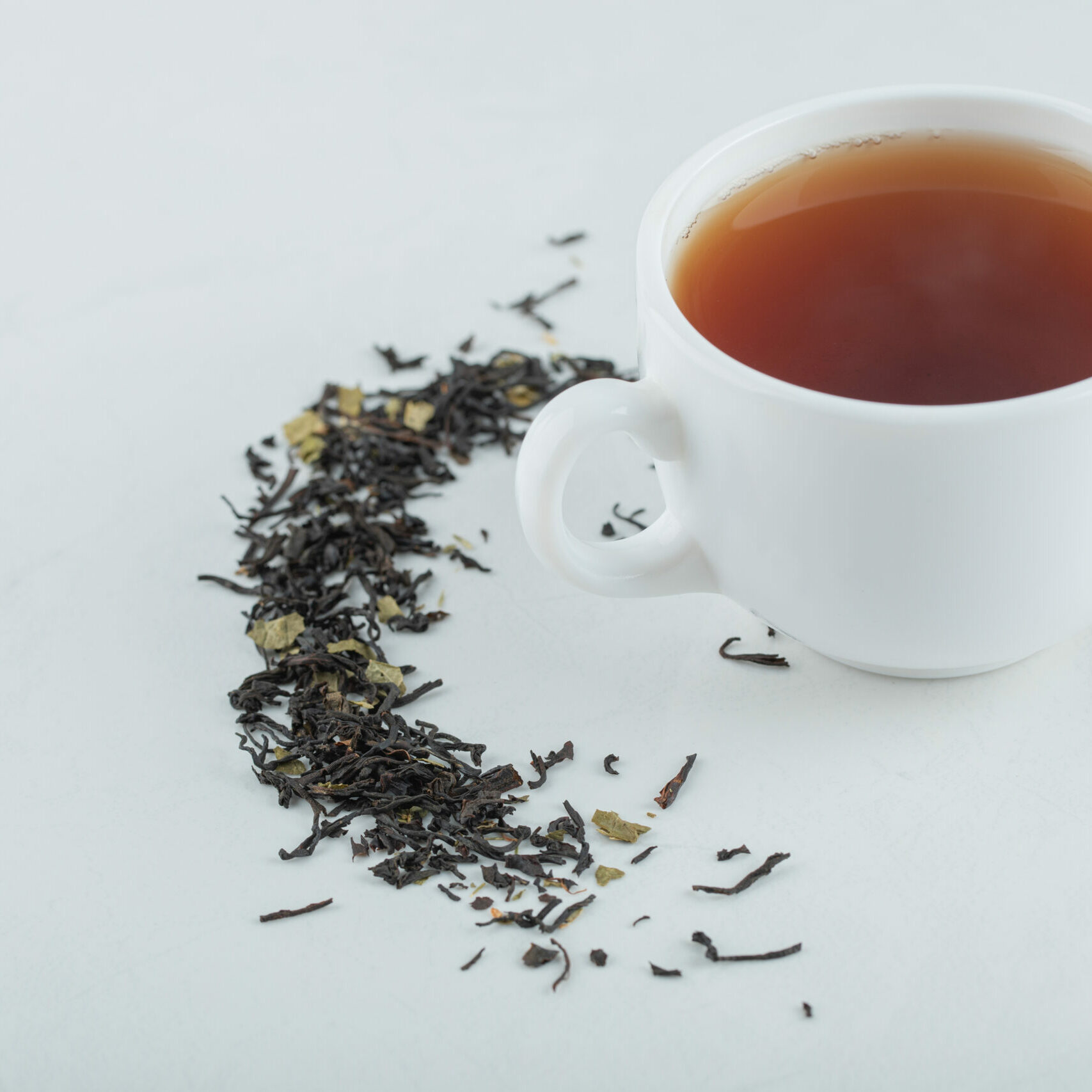 A cup of aroma tea with dried loose teas. High quality photo